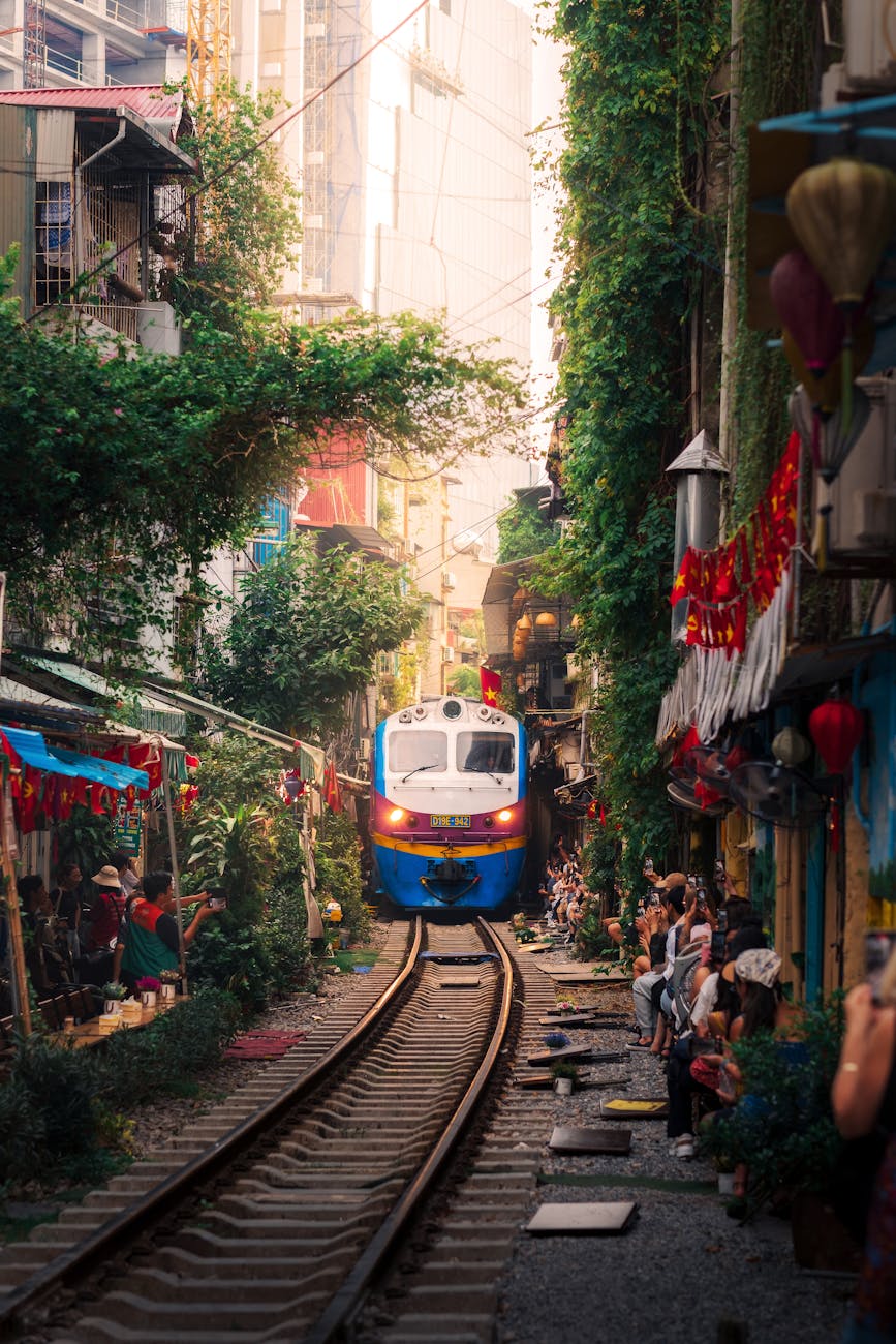 train passing through narrow street in hanoi